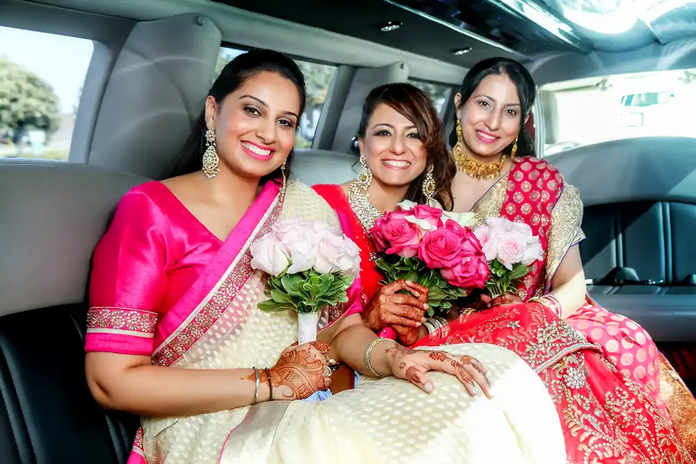 Bride And Bridesmaids in limousine indian wedding