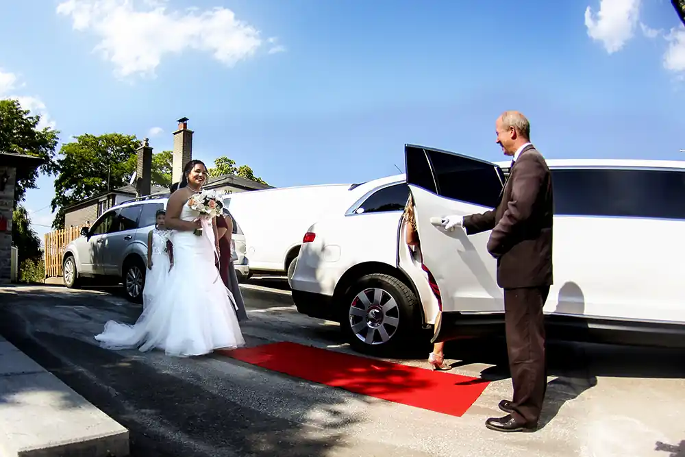 Bride With Driver Opening Door To A Limousine